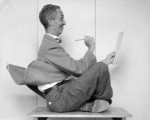 Bill Scovill, Photographer<br />
Reference Photograph of Norman Rockwell<br />Norman Rockwell says "Pan American Was My Magic Carpet Around the World”<br />Advertisement for Pan American Airways, 1956<br />
Inkjet print<br />
Norman Rockwell Collection<br />
©Norman Rockwell Family Agency.